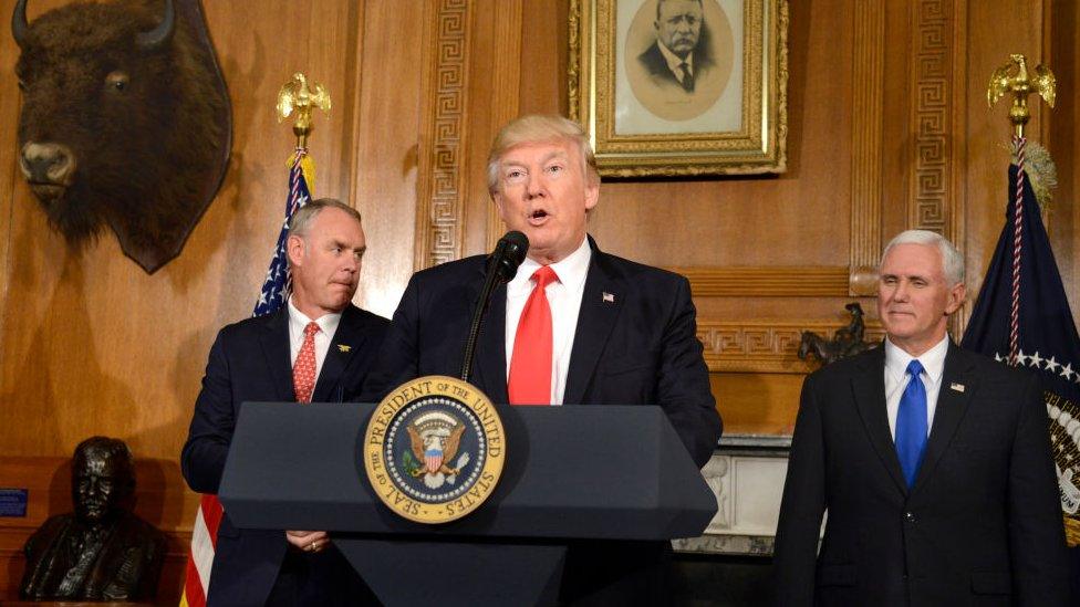 Mike Pence and Interior Secretary Ryan Zinke watch Donald Trump speak.