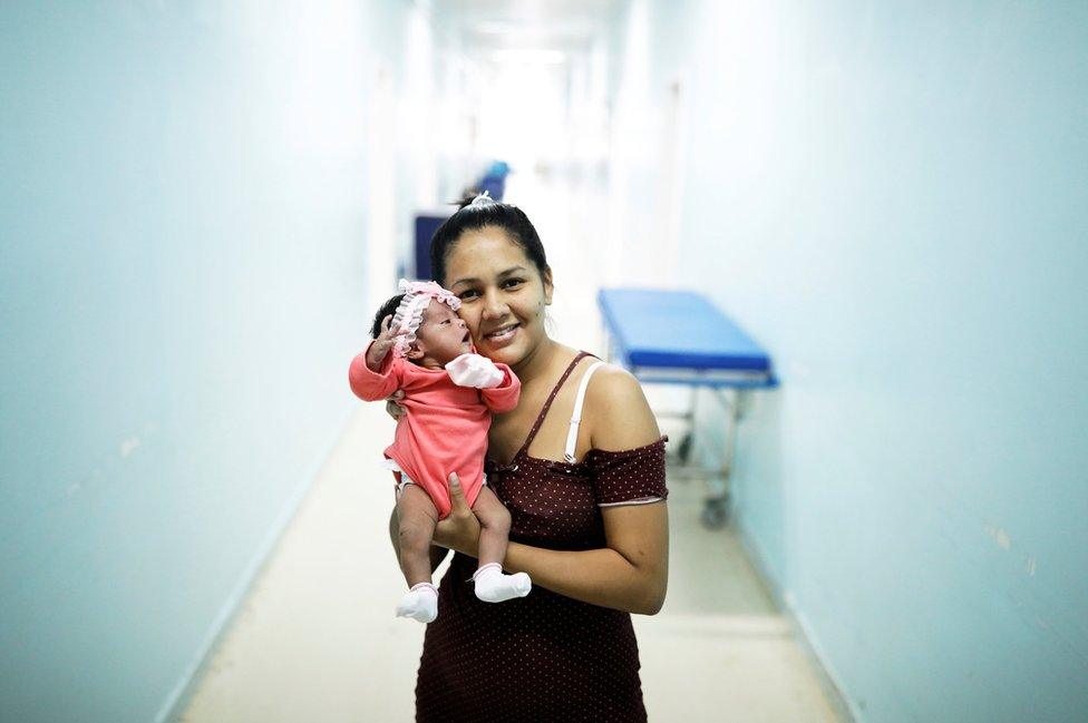 Irene, 23, a Venezuelan woman from Santa Elena city, holds her six-day-old baby Ashlei at a maternity hospital in Boa Vista, Roraima state, Brazil 21 August 2018