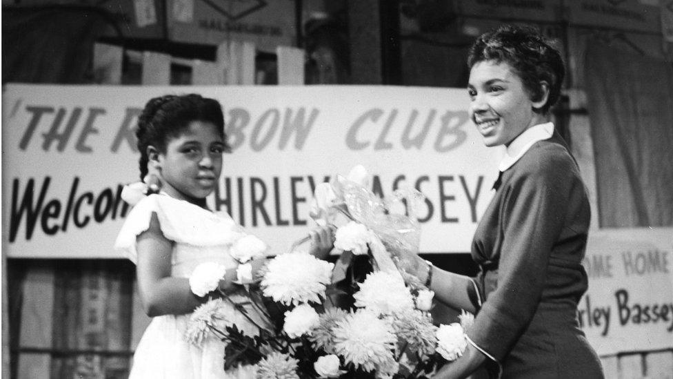 Shirley Bassey meets Gaynor Legall from The Rainbow Club for children from Cardiff's multicultural Docklands area in 1957