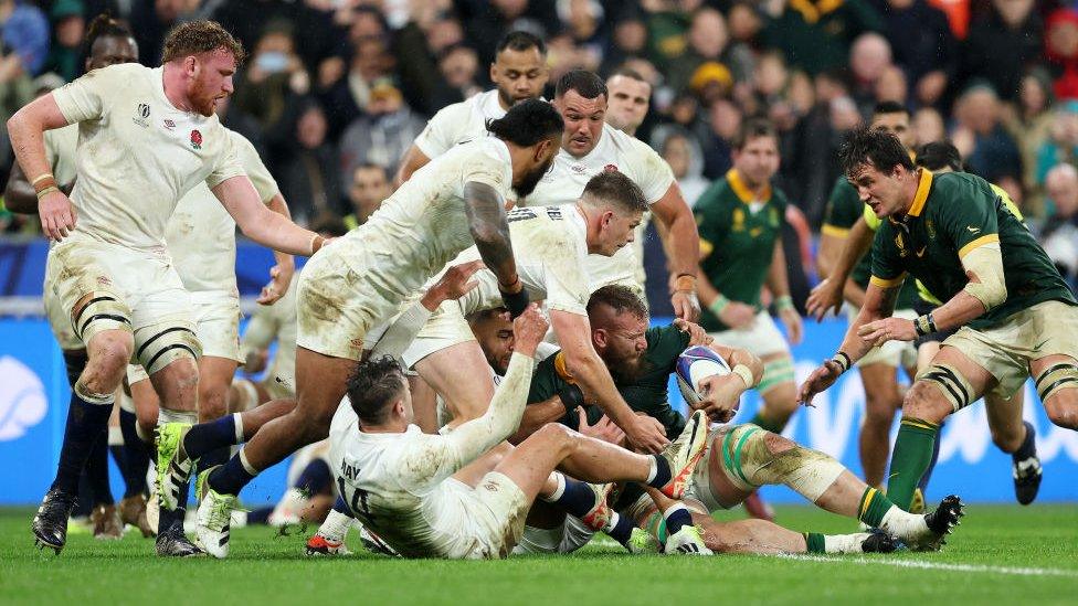 Players tackling for the try line