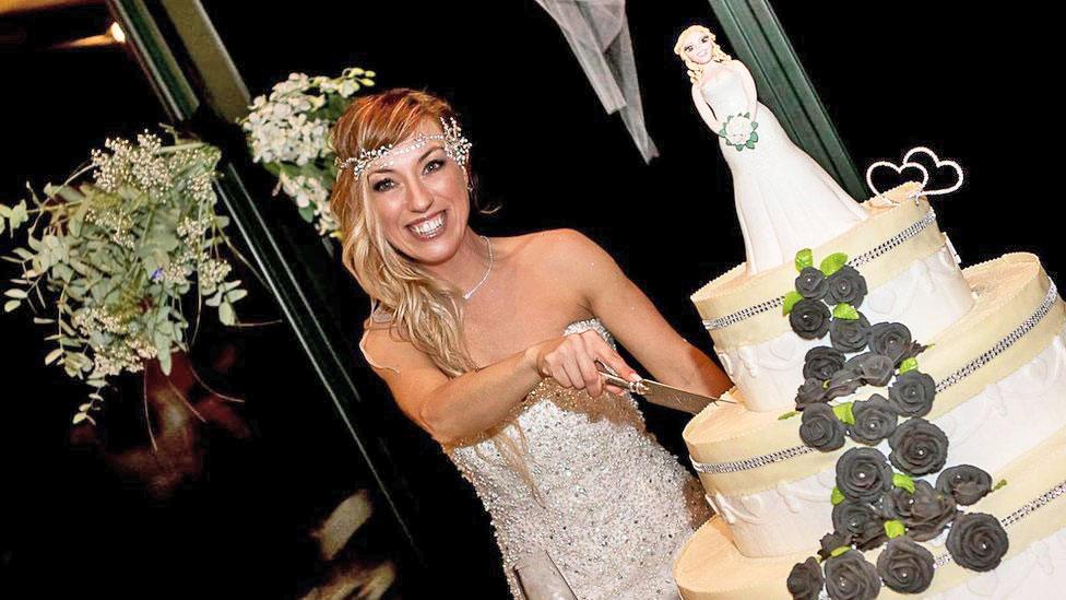 Laura Mesi, who married herself, cuts her wedding cake