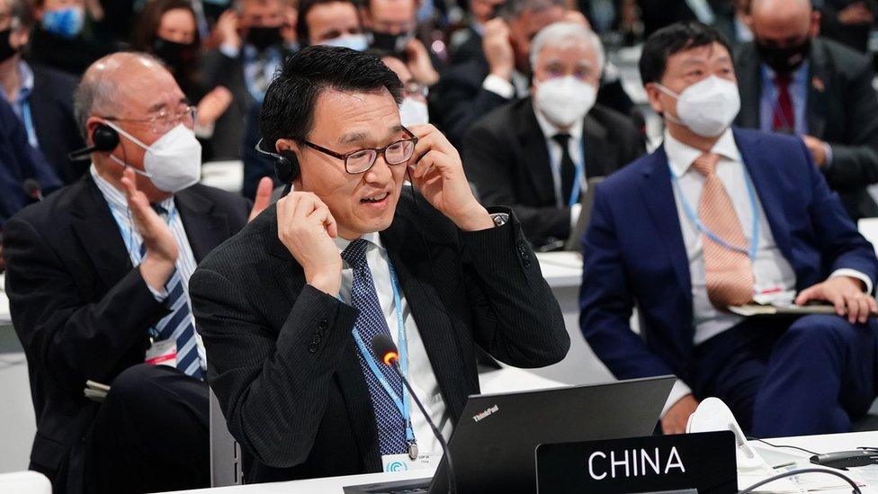 Chinese delegate Zhenhua Xie (rear left) and his team negotiate at a informal stock taking plenary session