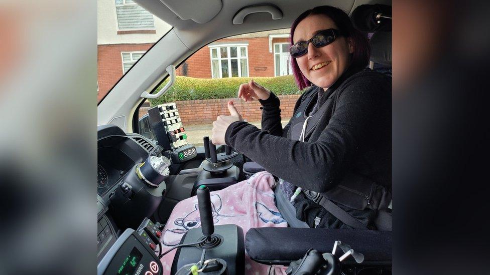 Charlotte driving in her modified van