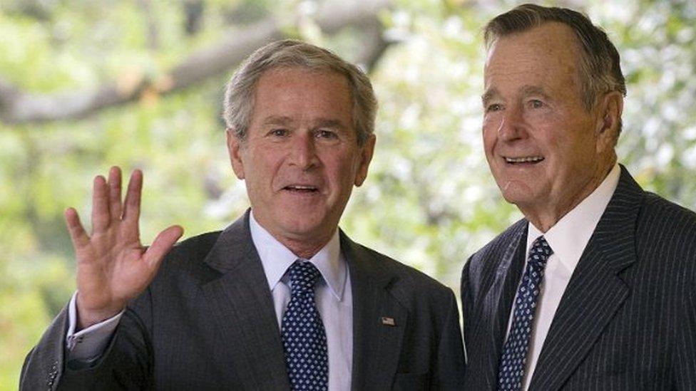 US President George W Bush waves as he leaves the Oval Office with his father, former President George H W Bush - 25 September 2008