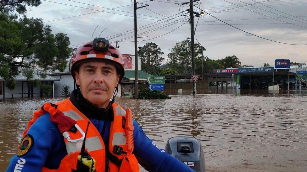 An emergency worker in the inundated New South Wales town of Lismore