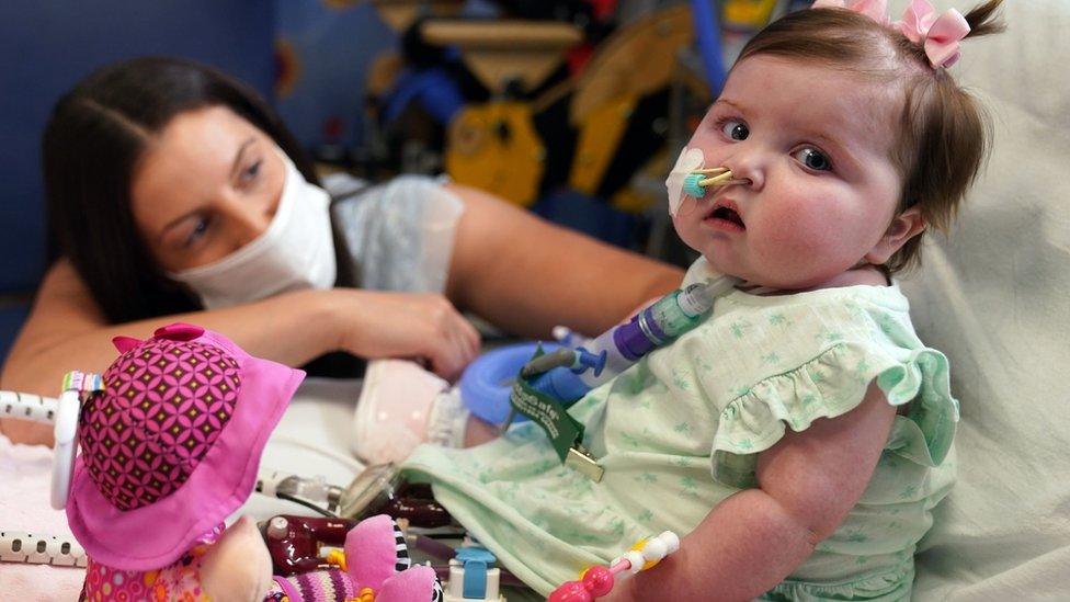 Leyla Bell, 10 months, with her mother Savana