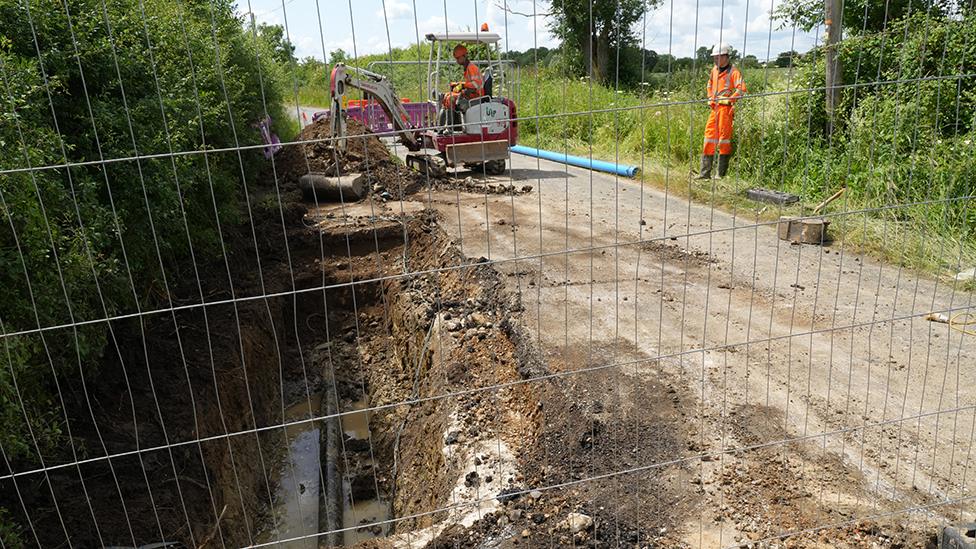 Engineers from Anglian Water fixing a pipe on Clare Road, Stansfield