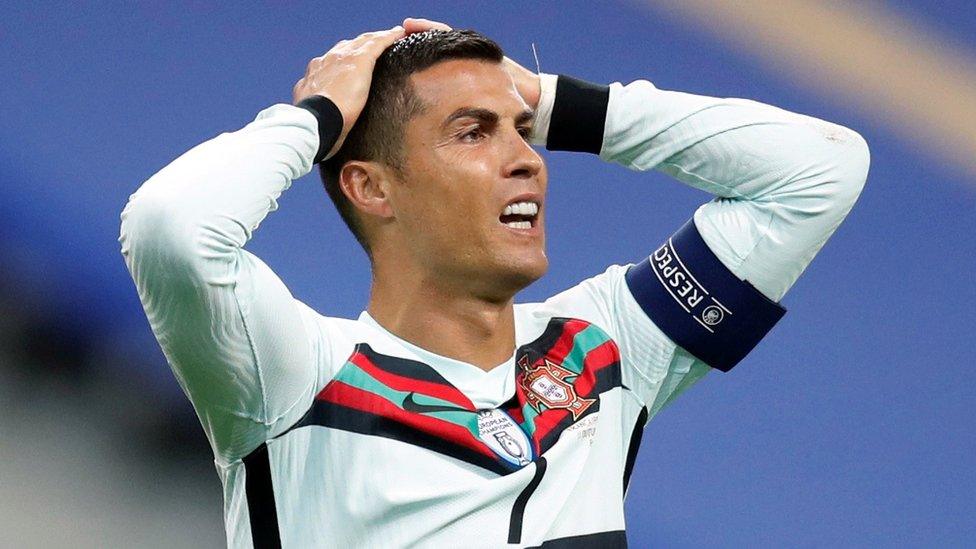 Ronaldo playing at the Portugal v France match, with his hands on his head