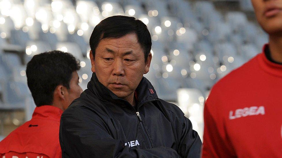 North Korea's coach Kim Jong-Hun (C) looks on as his players practice during a training session at Green Point stadium in Cape Town on June 20, 2010