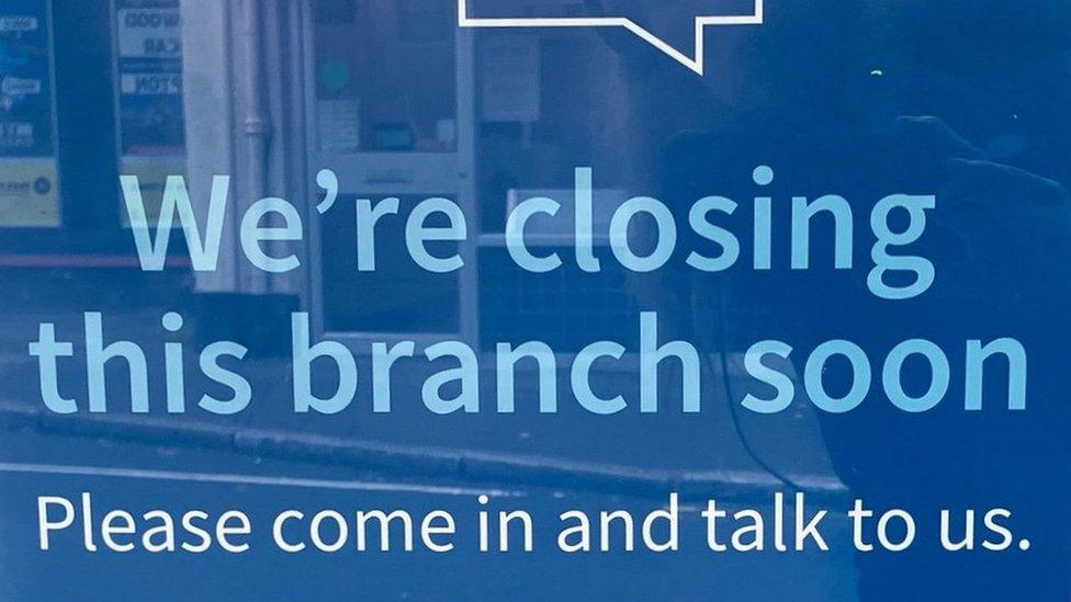 A sign in a bank window