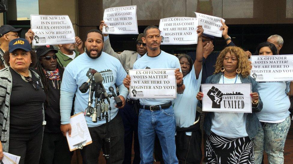 Communities United gathers at city hall on the first day of legal registration for ex-offenders