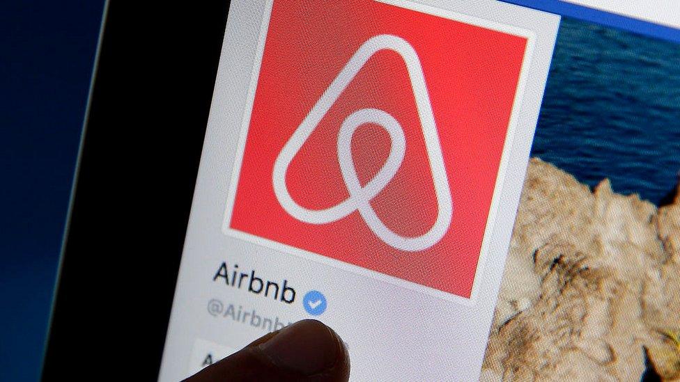 The Airbnb logo on a tablet