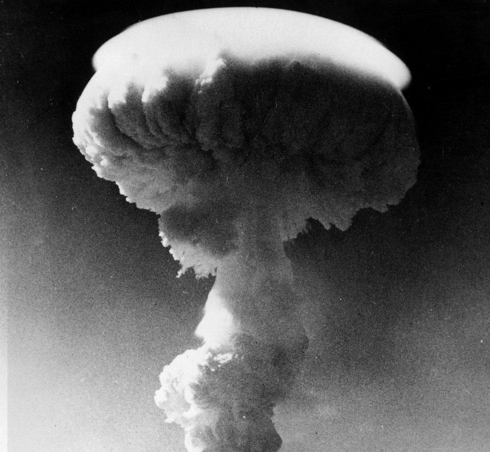 A mushroom cloud rises over the Pacific Ocean