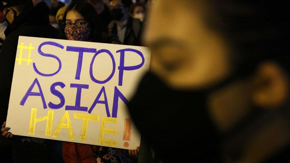 Activists participate in a vigil in response to the Atlanta spa shootings March 17, 2021 in the Chinatown area of Washington, DC