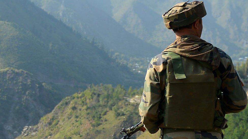 File photo of an Indian soldier looks towards the site of a gunbattle between troops and rebels inside an army brigade headquarters near the Line of Control (LoC)