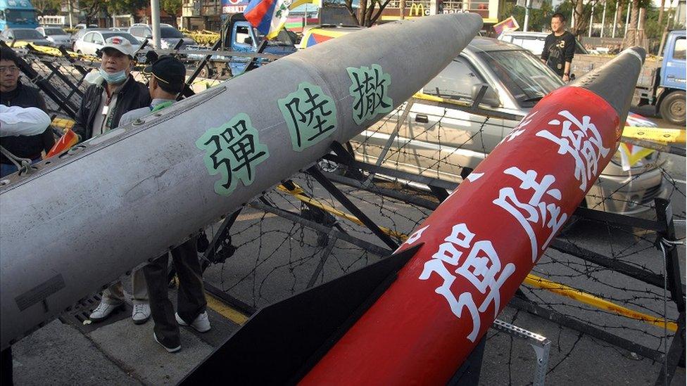 Protesters display two mock missiles to demand the Chinese government pull out their weapons aimed at the island from across the Taiwan Strait, during a demonstration outside the hotel in the central city of Taichung where Chen Yunlin, the mainland's top Taiwan negotiator, is staying during his visit on December 22, 2009