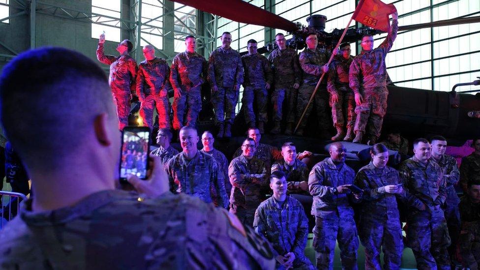 U.S. soldiers stand on an Apache attack helicopter prior to the arrival of U.S. Vice President Mike Pence at a military base on February 13, 2019 in Warsaw, Poland.