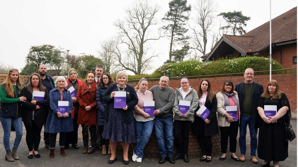 Chelsey Campbell, Carley McKee, Colin Griffiths, Fiona Carr, Charlotte Cheshire, Rhiannon Davies, Richard Stanton, Kayleigh Griffiths, Donna Ockenden, Nicky Lauder, David Boylett, Hayley Matthews, Steph Hotchkiss, Julie Rawlings, Neil Rawlings and Sonia Leigh stand with the final Ockenden report at The Mercure Shrewsbury Albrighton Hotel, Shropshire.