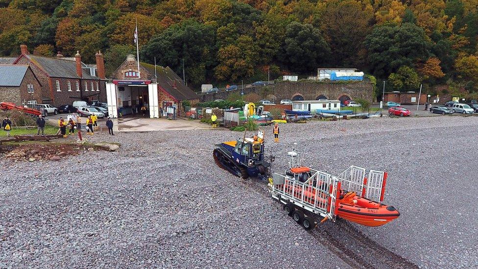 Lifeboat station with lifeboat on trailer in the foreground