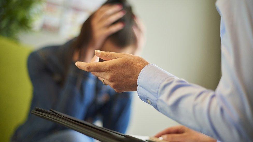 A distressed woman with a counsellor