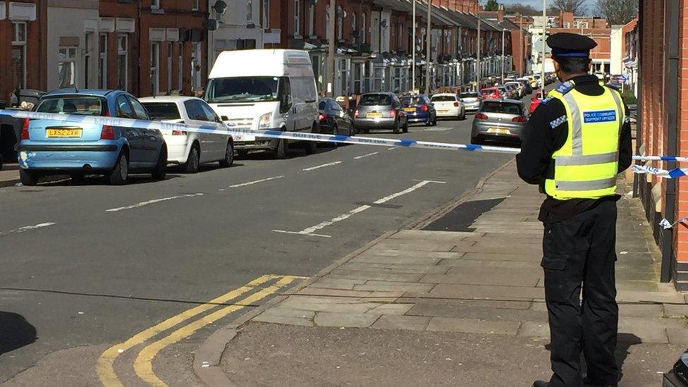 Police officer stands at the cordon