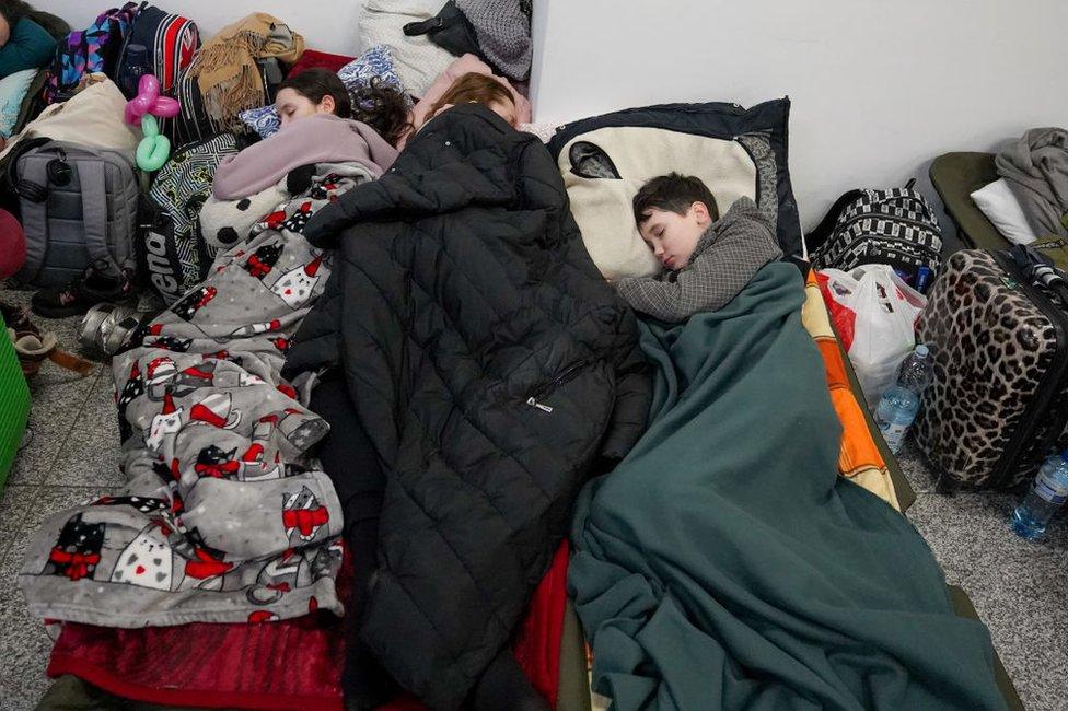 Children sleeping at Krakow station