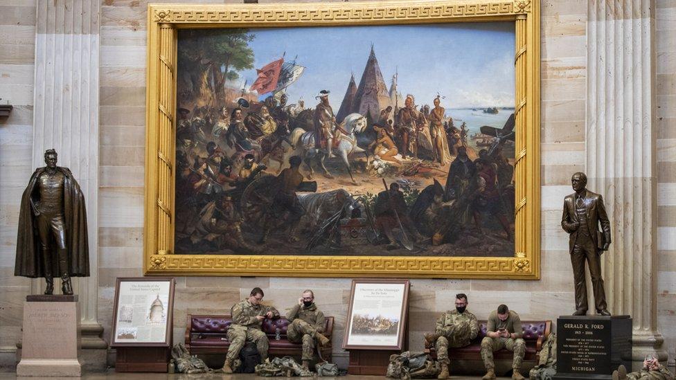 National Guard troops rest inside Capitol building