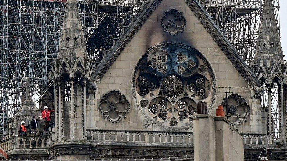 Inspectors are seen on the roof of Notre-Dame Cathedral