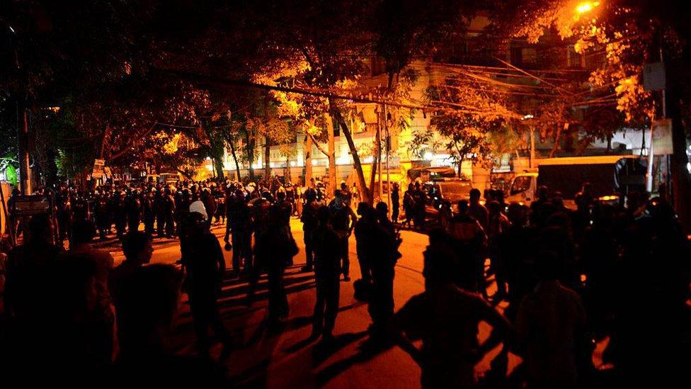 Bangladeshi security personnel stand guard in Dhaka on the night of the seige