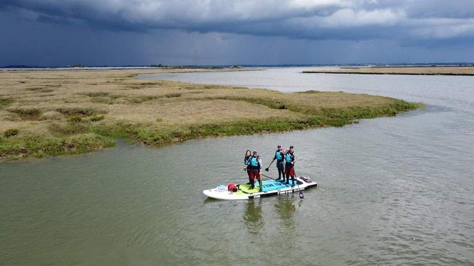 Oli Jordan, Andy Large, Jess Ashley and Matt Payne on the paddleboard