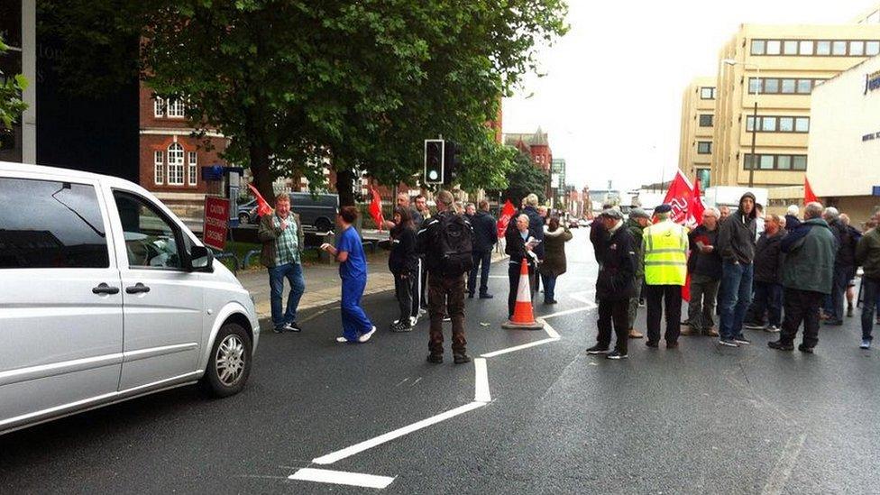 demonstrators on road