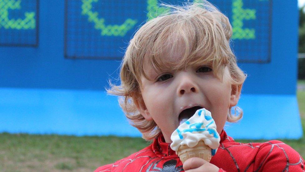 Mae Jessie o'r Fenni yn mwynhau ei frecwast hufen ia tu fas y Lle Celf // You can never have too much ice cream