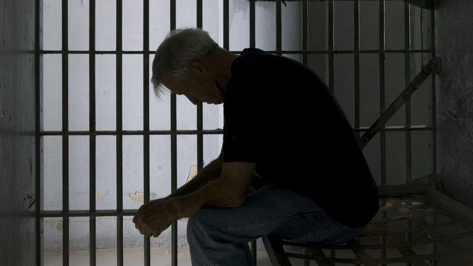 A man in a prison cell