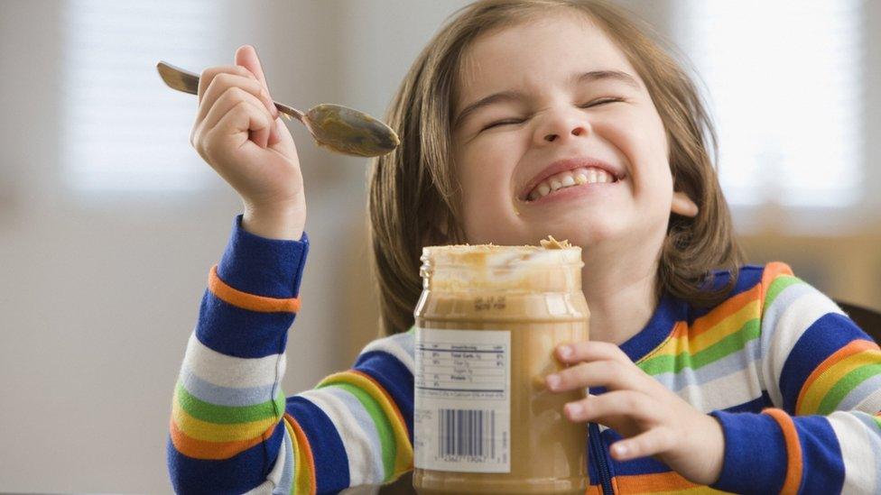 Child eating peanut butter