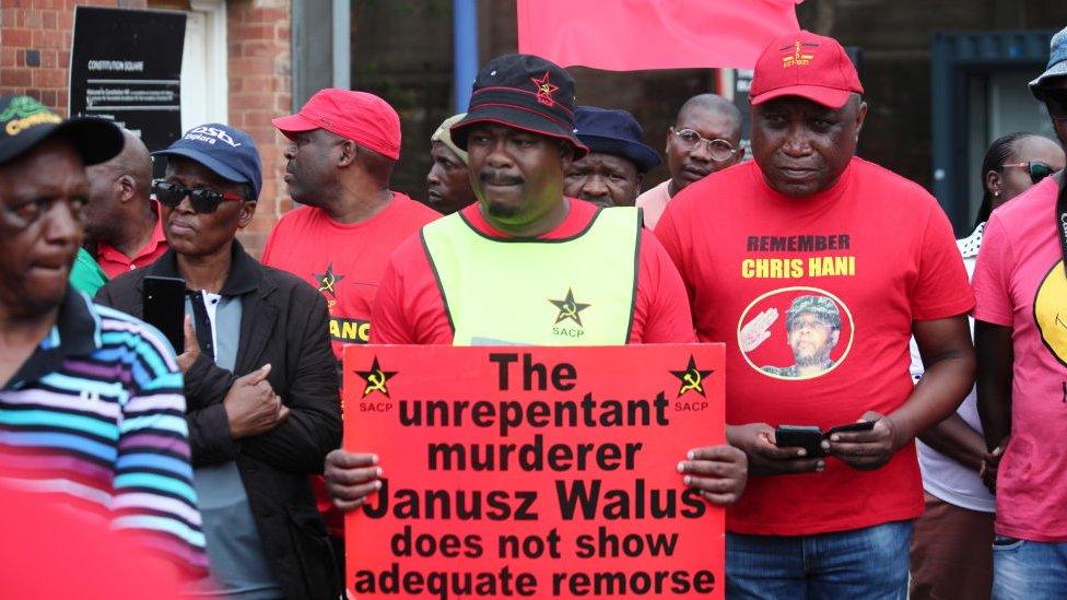 Members of the African National Congress (ANC), the South African Communist Party (SACP) and the Congress of South African Trade Unions (COSATU) picket at the Constitutional Court