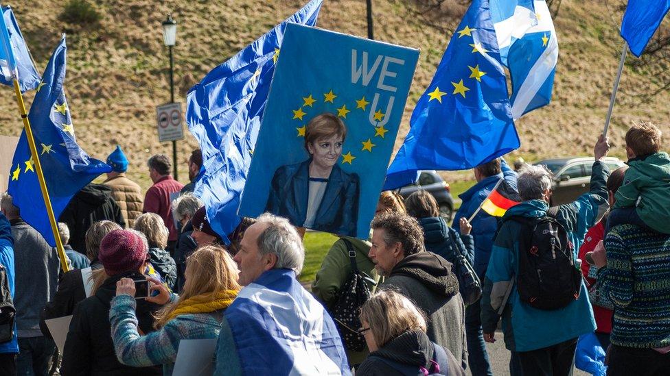 Nicola Sturgeon painting on a banner at an EU rally