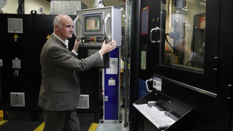 Martin Jennings at the coin striking machine