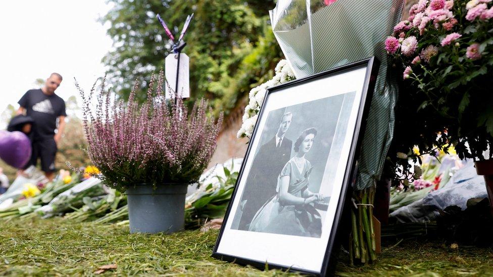 A portrait of Britain's late Queen Elizabeth and Prince Philip is placed beside floral tributes at the Sandringham Estate, in eastern England,