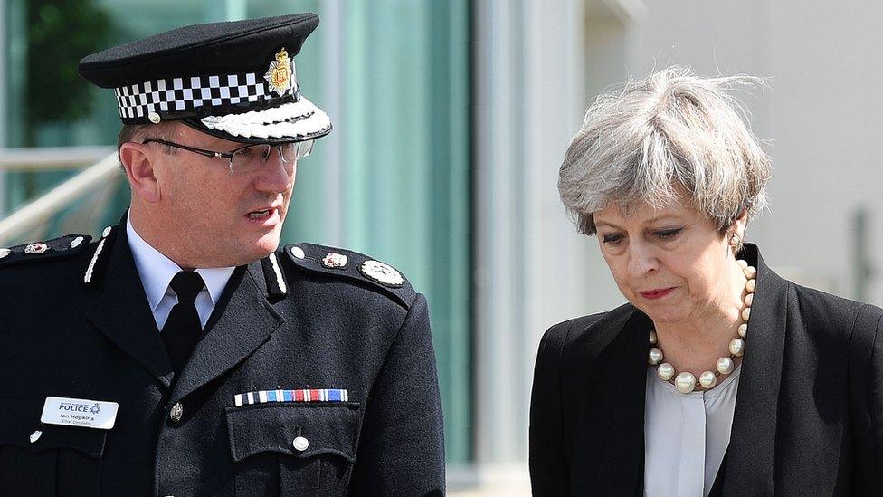 Prime Minister Theresa May (R) walks with Chief Constable of Greater Manchester Police, Ian Hopkins