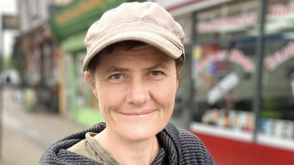 Nicola Strange, wearing a hat, standing on the street in St Paul's