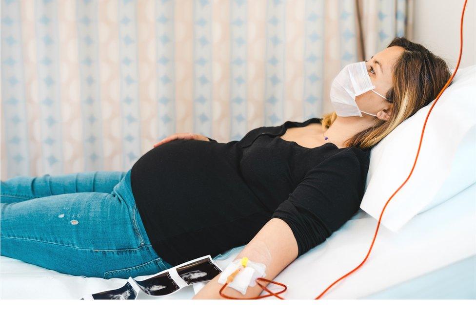 pregnant mother on hospital bed