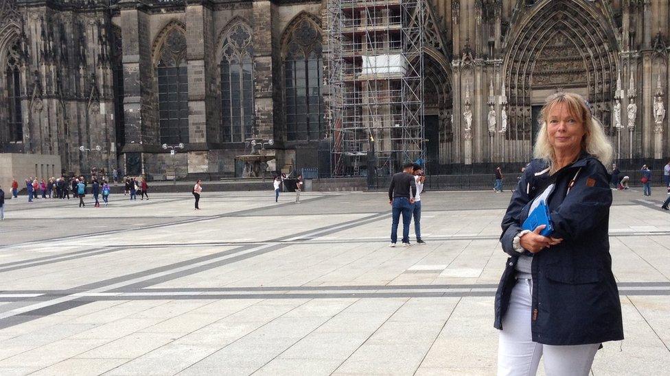 Monika Eisenberg standing outside Cologne Cathedral