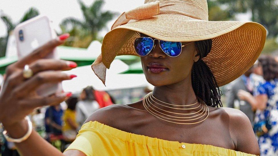 A woman taking a selfie at the Royal Ascot Goat Races in Kampala, Uganda - Saturday 25 August 2018