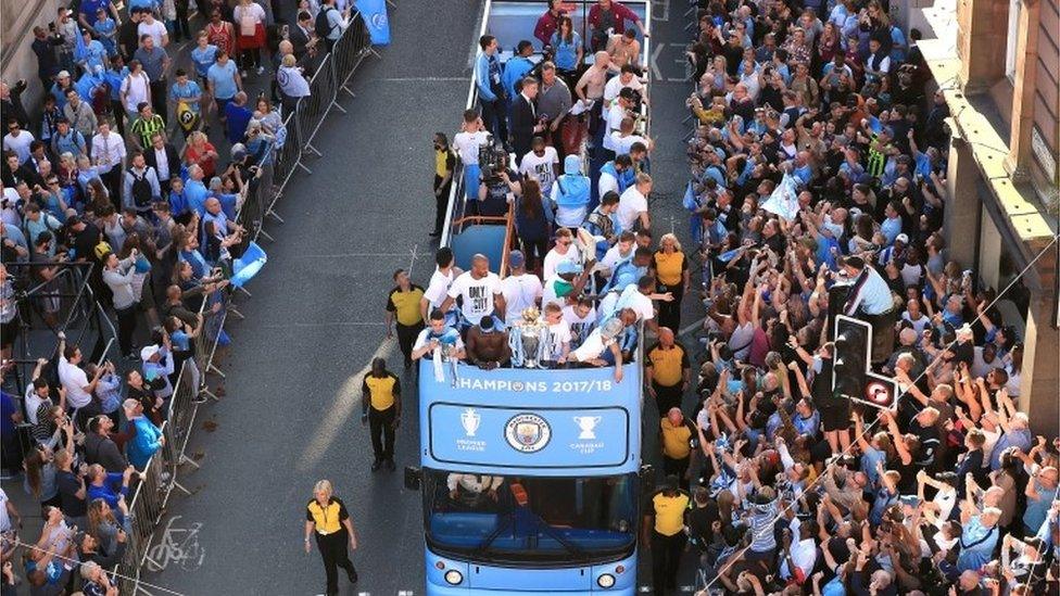 Manchester City players on a open-top bus during the Premier League champions trophy parade,