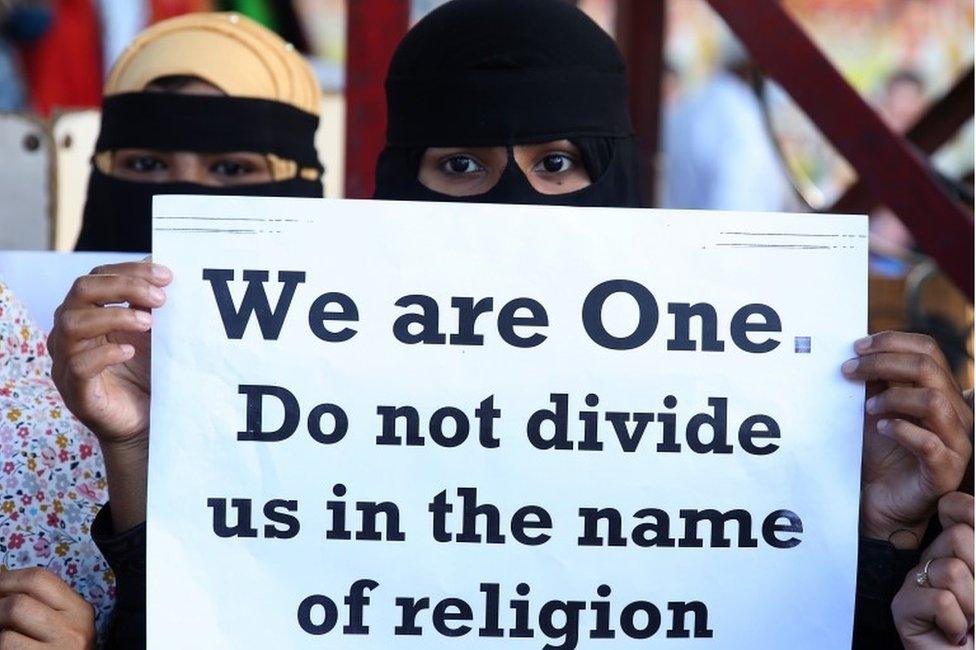 People from different human rights organizations hold placards during a protest against BJP-lead government and Chief Minister of Uttar Pradesh Yogi Adithyanath over the so-called "love Jihad" law,