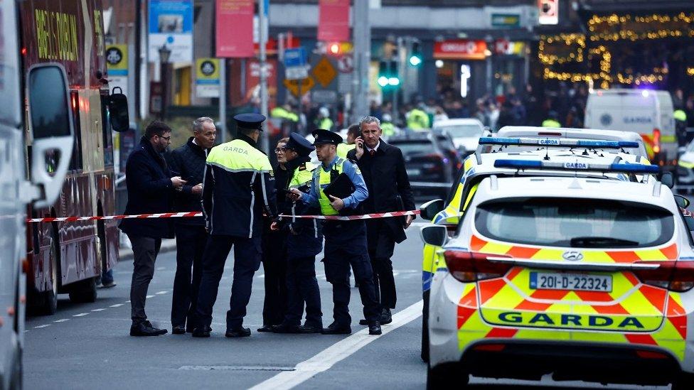 Police officers work at the scene of a suspected stabbing that left few children injured in Dublin