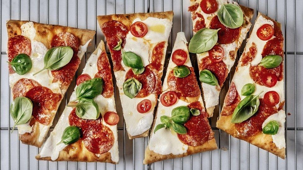 Slice of pizza on a rack.