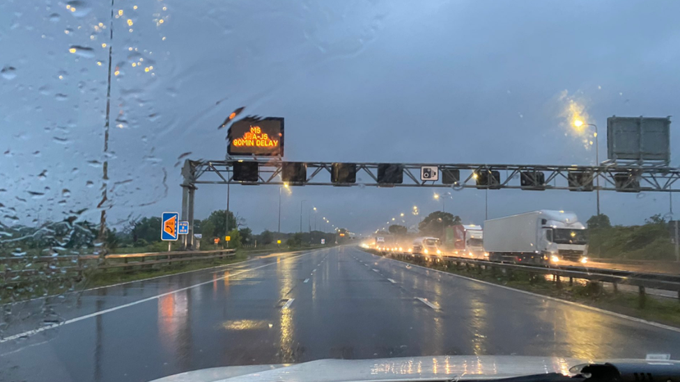 Flooded motorway seen from police car passenger window