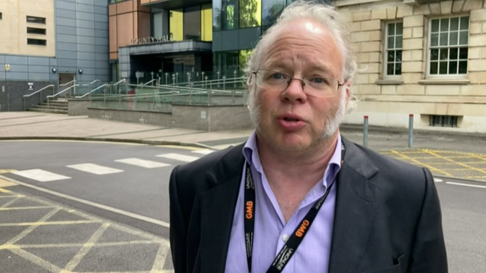 Union secretary Andy Newman stood outside the county hall council building