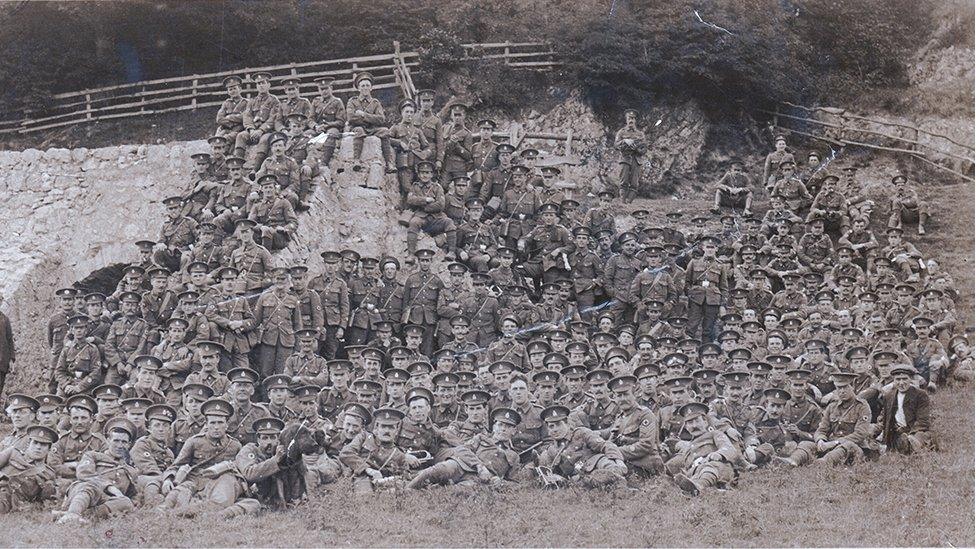 Men and Ginger the dog, their mascot, preparing for a route march during training in Prestatyn, north Wales, in 1915 before heading to France